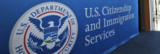 A U.S. Citizenship and Immigration Services sign is seen.