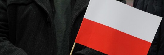 An elderly man seen holding a Polish flag. The last day of