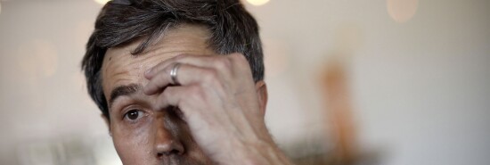 Democratic presidential candidate and former Texas congressman Beto O'Rourke wipes sweat from his brow as he speaks at a campaign stop.