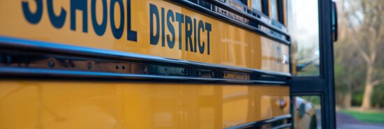 Side view closeup of yellow school bus with open door