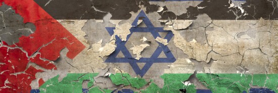 Israeli and Palestinian flags on a weathered wall.