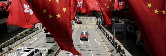 China and Kong Hong national flags are displayed outside a shopping center in Hong Kong.