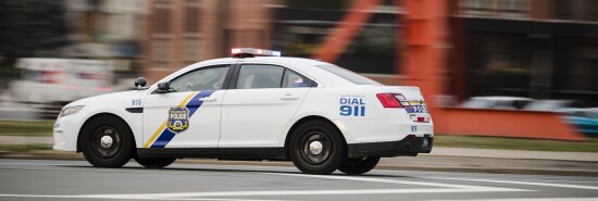 A police car drives with its lights flashing in Philadelphia.