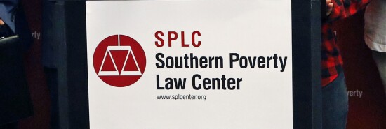 A sign containing the logo of the Southern Poverty Law Center.