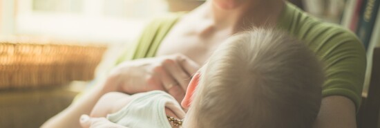 Mother breastfeeding baby in a cafe