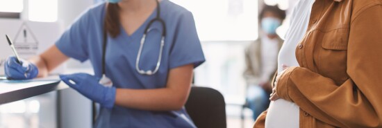 Pregnant Lady In Mask On Appointment At Doctor's Office