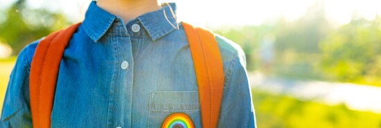 girl in denim t-shirt with rainbow symbol wear backpack in summer park outdoor