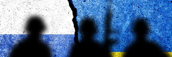 Flag of Russia and Ukraine painted on a concrete wall with soldiers shadows. Relationship between Ukraine and Russia