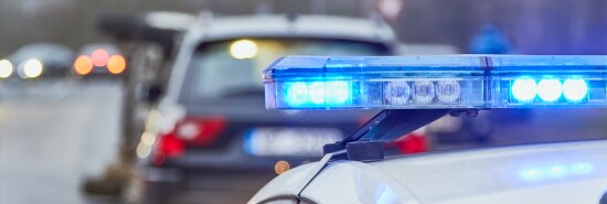 Blue lights of a police car at the scene of an accident