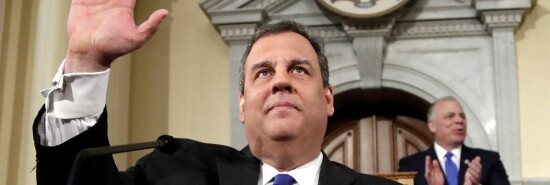 Then-Gov. Chris Christie, R-N.J., (left) gestures to lawmakers before delivering his final state of the state address at the Statehouse in Trenton, N.J.