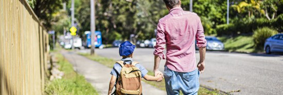 Father and son walking to school