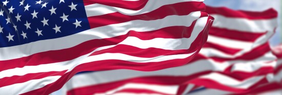 Three flags of the United States of America waving in the wind