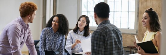 Young creatives brainstorming ideas around a table